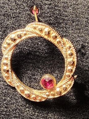 Gold-Tone Circular Pendant with Pink Gem Accent